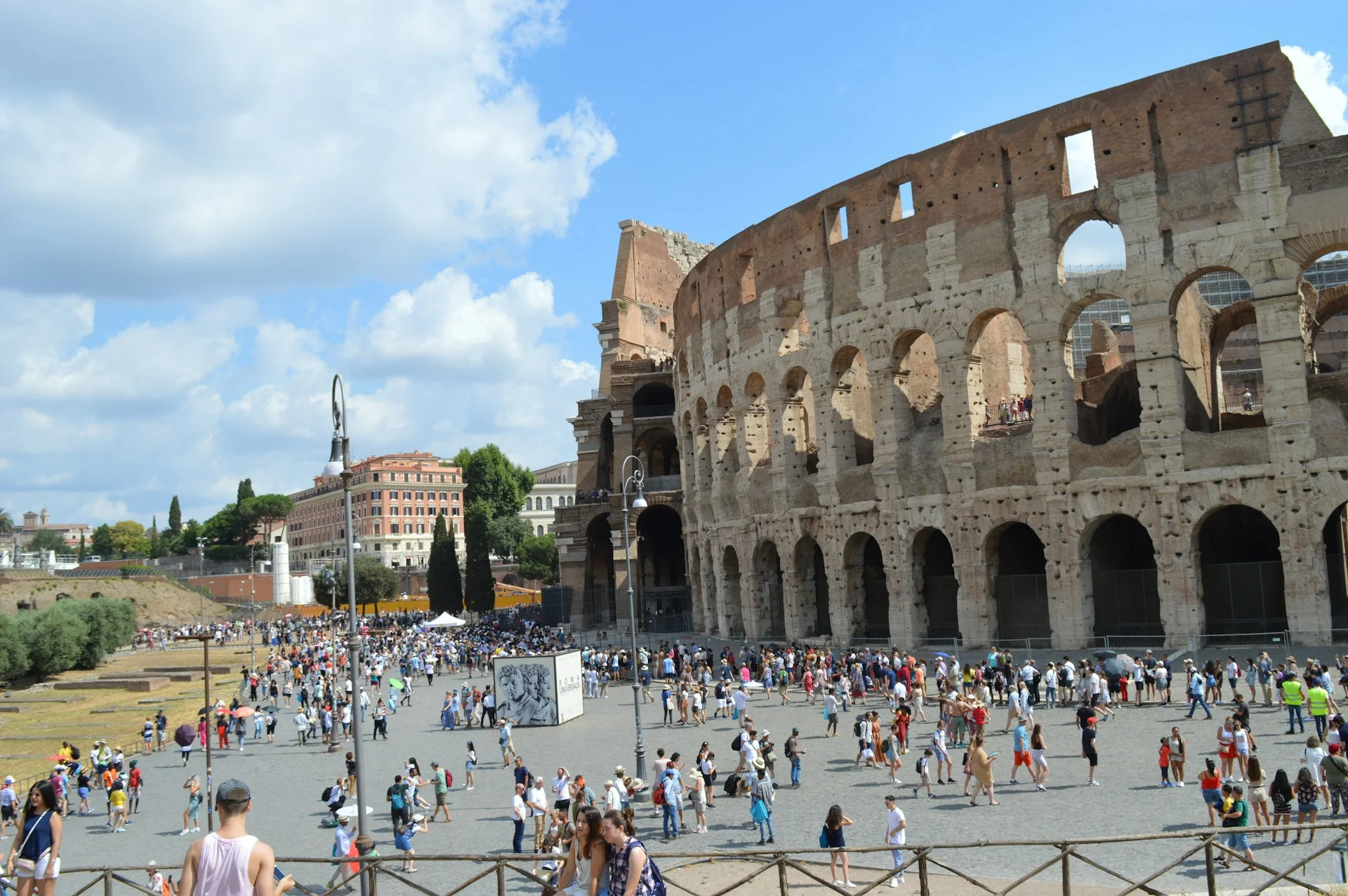 Colosseum amphitheatre in Rome, Italy, under a clear blue sky.